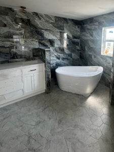 bathroom with Elysium Mystic Ocean 12x24 porcelain tile - freestanding tub and bathroom vanity