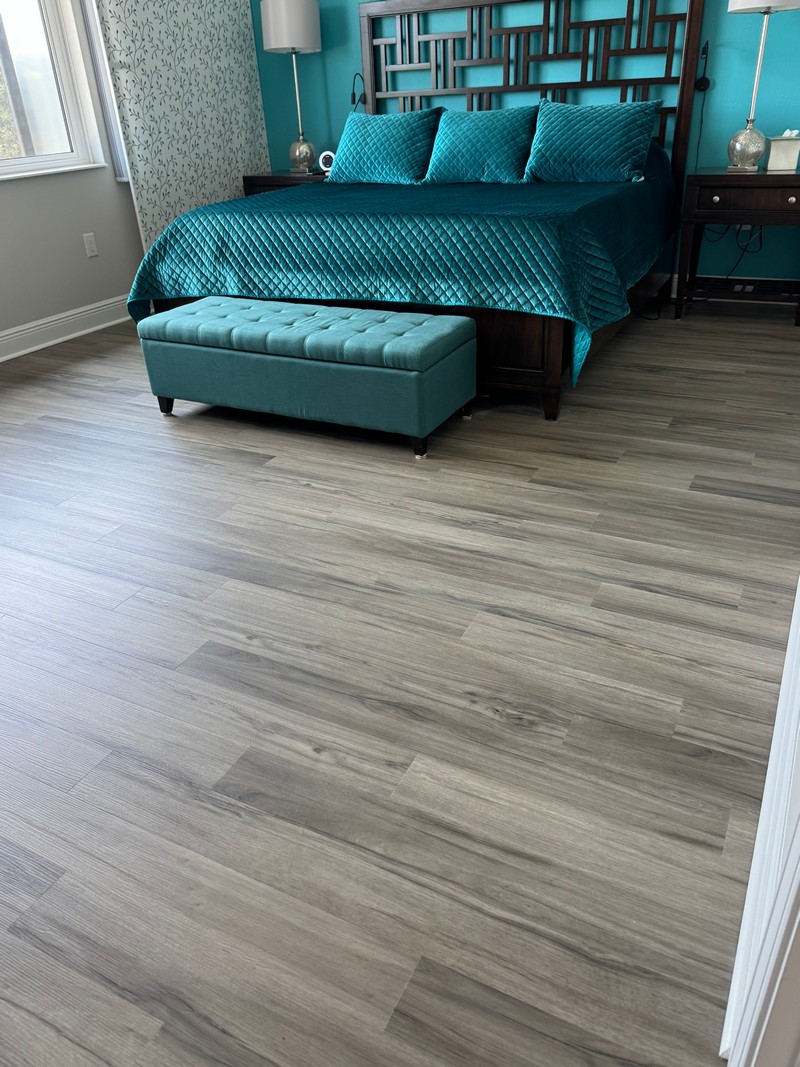 emerald green bed on Ashton Woods Oak COREtec Luxury Vinyl flooring