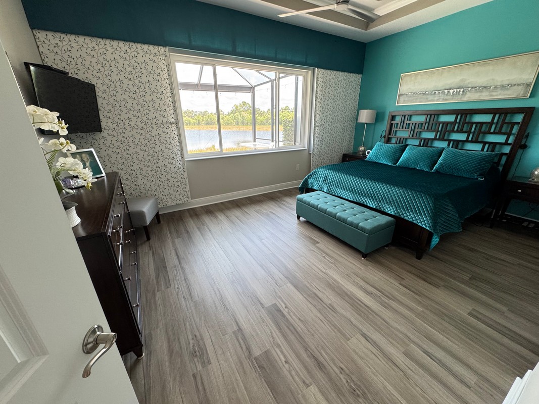 bedroom with emerald green furniture on Ashton Woods Oak COREtec Luxury Vinyl flooring