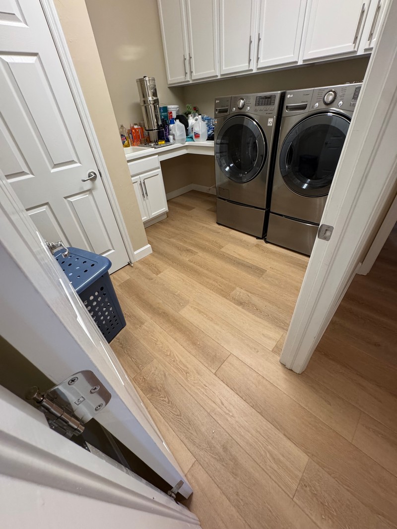 Wheat Oak COREtec Luxury Vinyl flooring in a laundry room